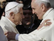 FILE - Pope Francis, right, hugs Pope Emeritus Benedict XVI prior to the start of a meeting with elderly faithful in St. Peter's Square at the Vatican, Sunday, Sept. 28, 2014. Pope Francis on Wednesday, Dec.