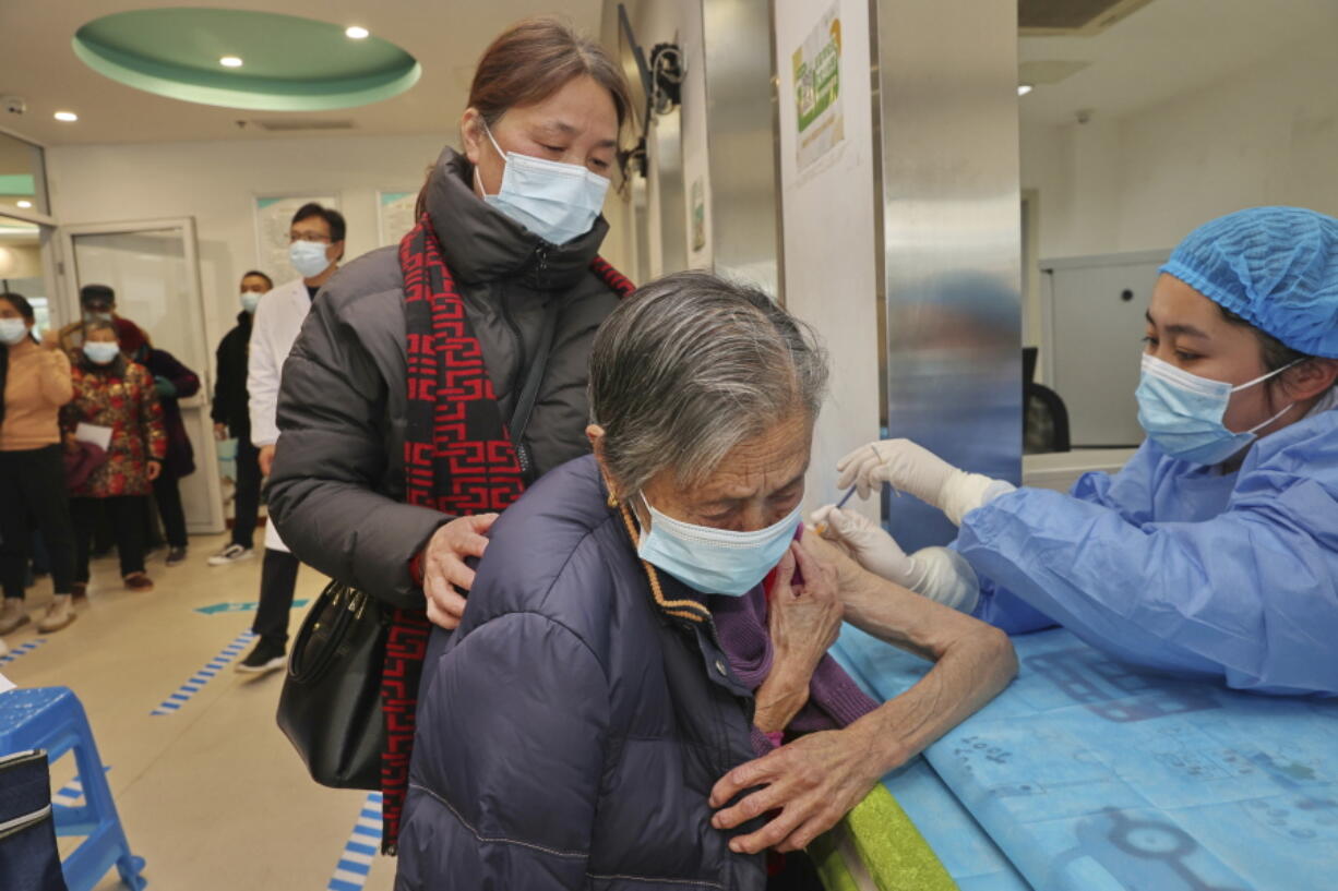 A nurse gives a shot of COVID vaccine to an old woman Dec. 9 at a community health center in Nantong in eastern China's Jiangsu province. Nearly three years after it was first identified in China, the coronavirus is now spreading through the vast country.