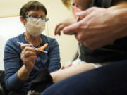 Deborah Sampson, left, a nurse at a University of Washington Medical Center clinic in Seattle, gives a Pfizer COVID-19 vaccine shot to a 20-month-old child, June 21, 2022, in Seattle. The U.S. on Thursday, Dec. 8, 2022 open doses of the updated COVID-19 vaccines for most children younger than age 5. The Food and Drug Administration's decision aims to better protect the littlest kids from severe COVID-19 at a time when children's hospitals already are packed with tots suffering a variety of other respiratory illnesses, too. (AP Photo/Ted S.