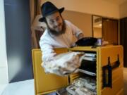 Eli Chitrik from Turkey shows bagel sandwiches in his hotel room in Doha, Qatar, on Monday.