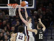 Gonzaga forward Drew Timme (2), second from right, shoots in front of Washington forward Jackson Grant (12) during the first half of an NCAA college basketball game, Friday, Dec. 9, 2022, in Spokane, Wash.