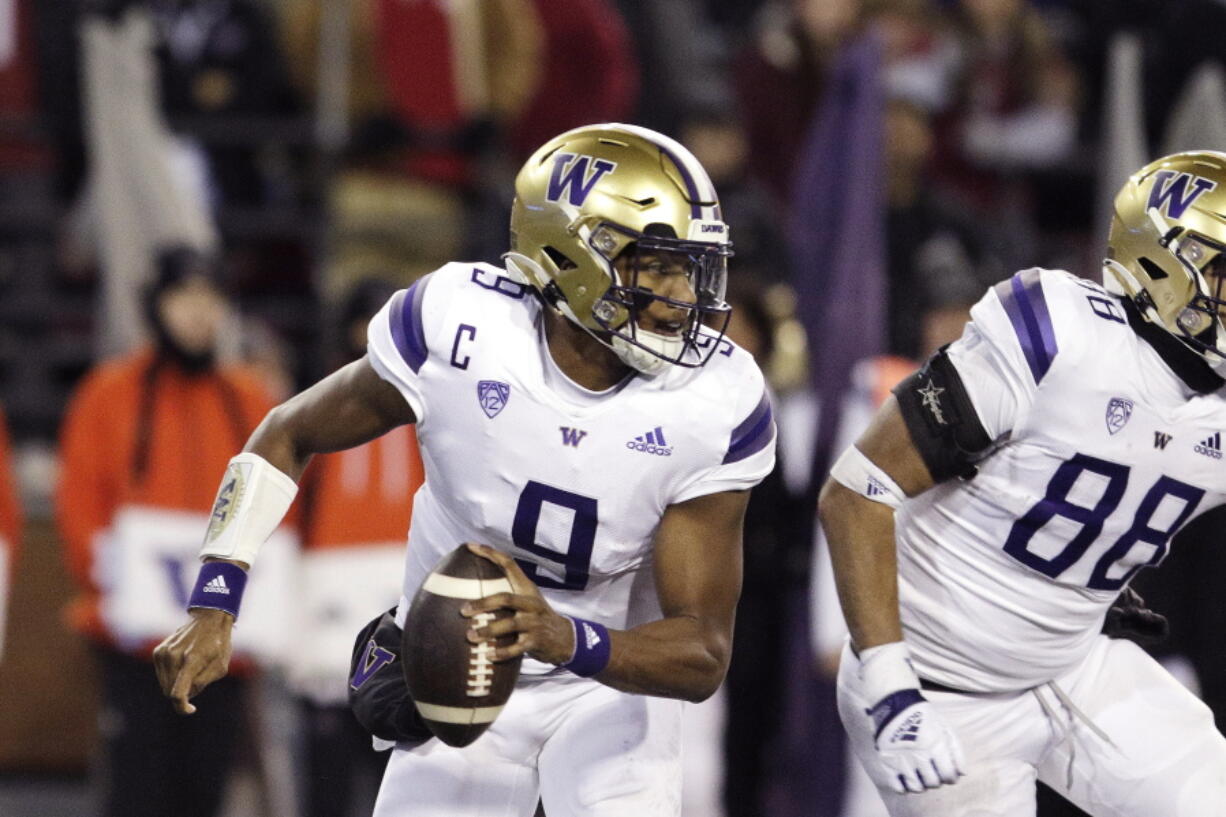 Washington quarterback Michael Penix Jr. (9) looks for a receiver during the second half of an NCAA college football game against Washington State, Saturday, Nov. 26, 2022, in Pullman, Wash. Washington won 51-33.