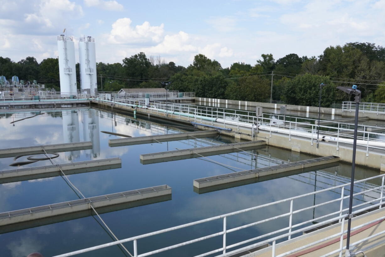 FILE - Clouds are reflected off the City of Jackson's O.B. Curtis Water Treatment Facility's sedimentation basins in Ridgeland, Miss., Sept. 2, 2022. Officials in Jackson said the city's water system, which partially collapsed in late August, was experiencing "fluctuating" pressure on Saturday, Dec. 24, amid frigid temperatures. (AP Photo/Rogelio V.