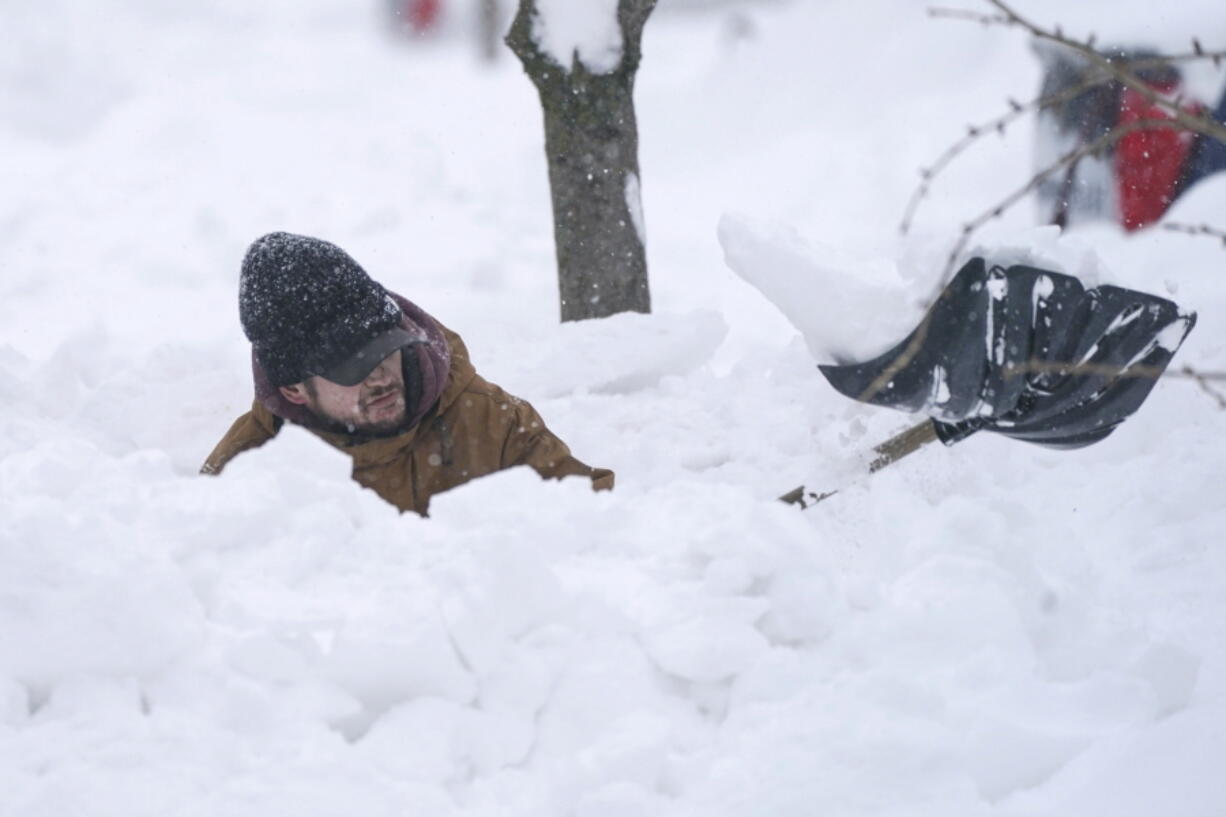 Tommy Roetzer digs out his driveway on West Delavan Street in Buffalo, N.Y., on Monday, Dec. 26, 2022.