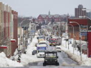 Vehicles drive down Jefferson Avenue in Buffalo. N.Y., on Wednesday, Dec. 28, 2022. Clean-up efforts remain underway after a blizzard hit four Western New York counties.