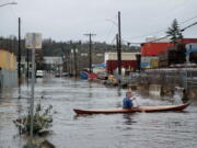 A person kayaks on South Portland Street in Seattle's South Park neighborhood Tuesday morning, Dec. 27, 2022.