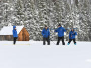 Second from the right, Sean de Guzman Chief of the California Department of Water Resources Snow Surveys and Water Supply Forecasting Section, Andy Reising, right, and Anthony Burdock left, both California Department of Water Resources Engineers in the Snow Surveys and Water Supply Forecasting Unit, work the measurement phase of the first media snow survey of the 2023 season, as California Department of Water Resources Director Karla Nemeth watches the survey at the Phillips Station site in the Sierra Nevada Mountains. The survey is held approximately 90 miles east of Sacramento off Highway 50 in El Dorado County on Jan. 3, 2023.