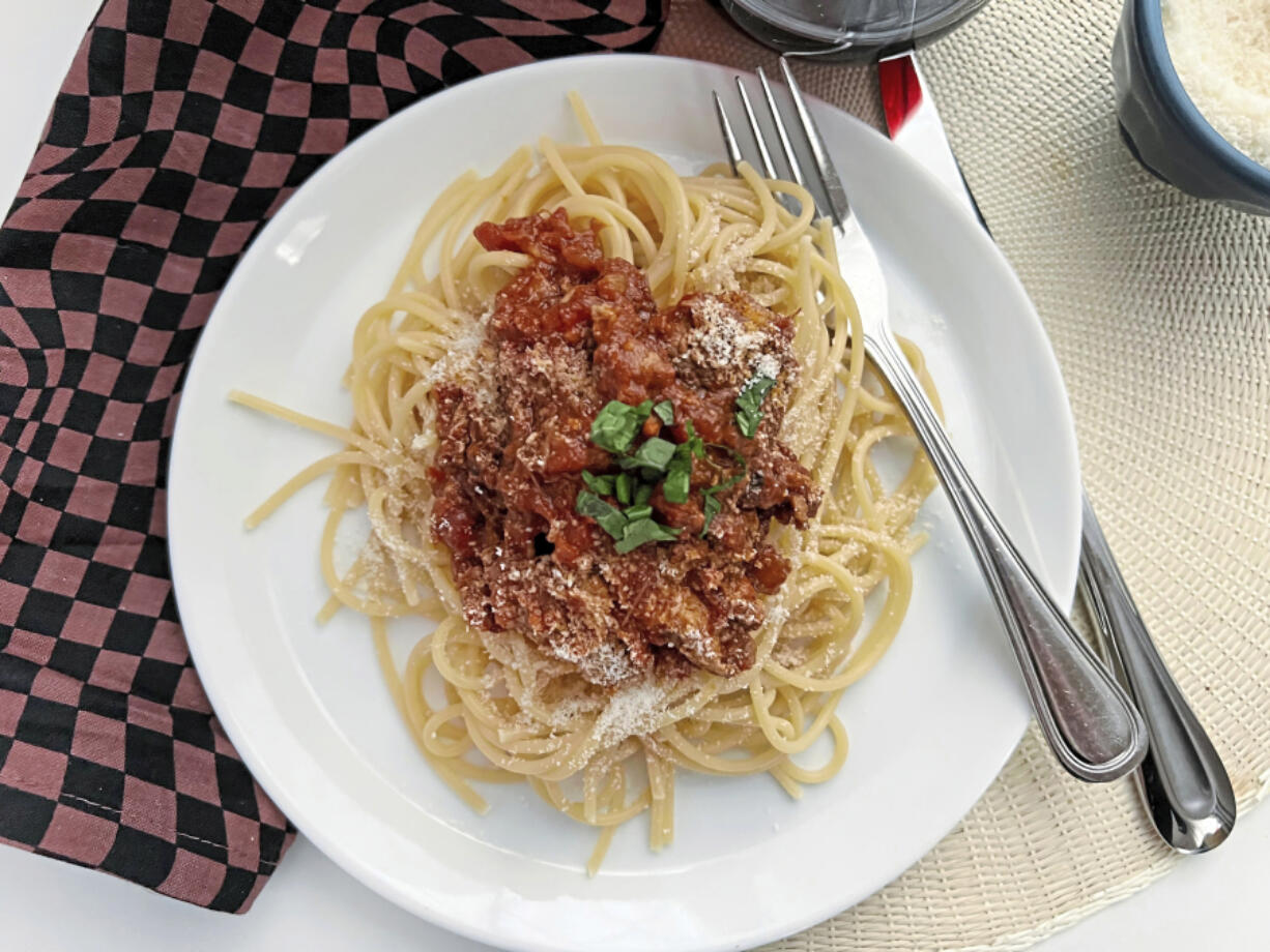 Made with slow-cooked pork shoulder, sausage and meatballs, this rich Sunday sauce can be served on any kind of pasta.