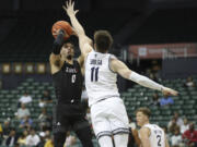 Seattle U. guard Alex Schumacher (0) shoots over Utah State's Max Shulga (11) during a game in the Diamond Head Classic in December at Honolulu.