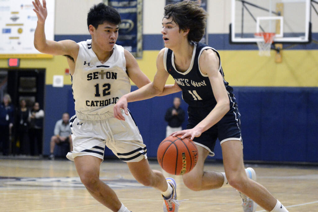 King’s Way Christian’s Giovanny Evanson, right, looks to drive against Seton Catholic’s Lance Lee during a Trico League boys basketball game on Thursday, Jan. 12, 2023, in Vancouver.