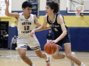 King’s Way Christian’s Giovanny Evanson, right, looks to drive against Seton Catholic’s Lance Lee during a Trico League boys basketball game on Thursday, Jan. 12, 2023, in Vancouver.