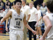 Seton Catholic’s Lance Lee, left, high fives teammate Brady Angelo, right, at halftime of a Trico League boys basketball game  against King’s Way Christian on Thursday, Jan. 12, 2023, in Vancouver.