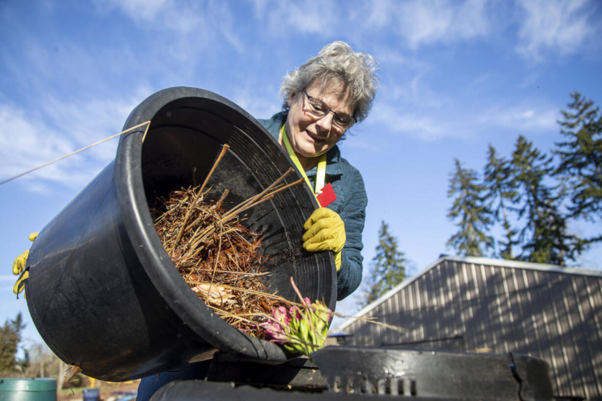 Master Gardener Jackie Trimble, 68, checks on compost in the backyard of her home in Lake Stevens, Washington on Wednesday, Jan. 11, 2023.