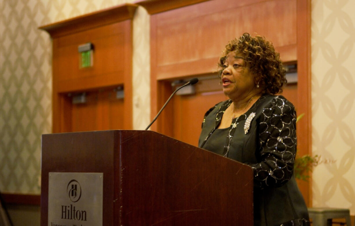 Pastor Joyce Smith leads the crowd in a rendition of "Lift Every Voice and Sing" during the 13th annual "Reverend Dr. Martin Luther King Jr. Breakfast Celebration" hosted by iUrban Teen.