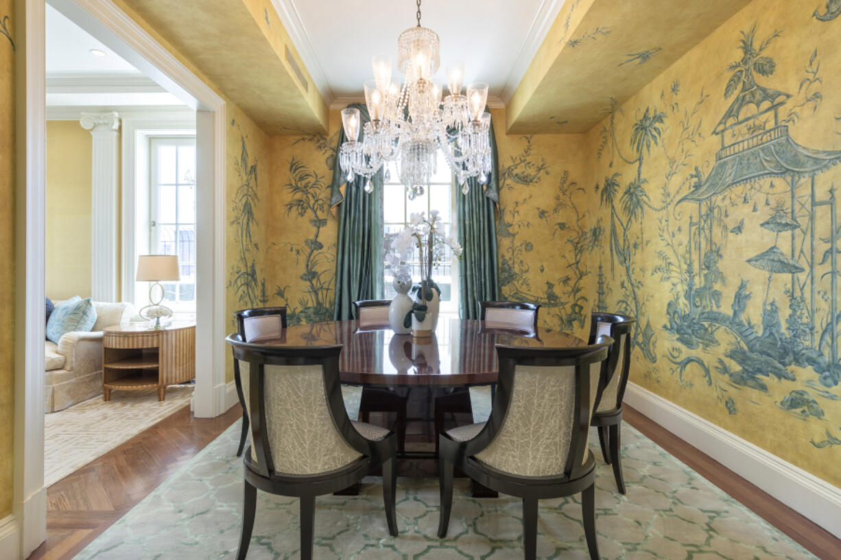 Hand-painted original art creates a traditional and formal feel in this dining space.