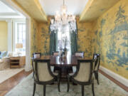 Hand-painted original art creates a traditional and formal feel in this dining space.