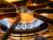 A burner on a stove emits blue flames from natural gas in Des Plaines, Ill. Gas stoves are taking heat from environmental groups and government agencies.