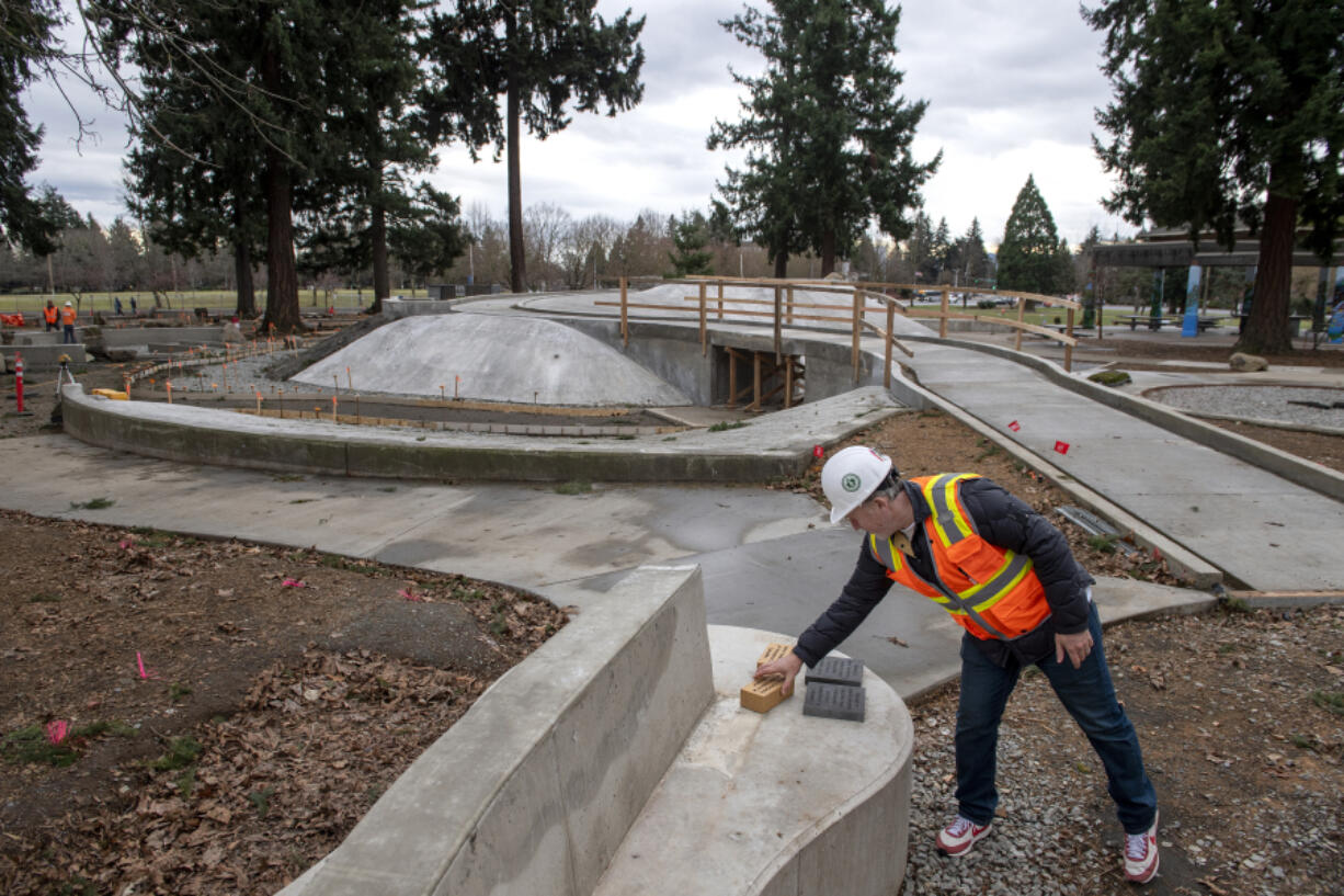 Cody Goldberg, co-founder of Harper's Playground, looks over fundraising bricks and paver stones as construction continues at Marshall Park. The group is working to build a new, inclusive playground for varying ability levels.