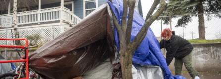 Angellina Ricker, 23, fixes the rain cover around the tent she shares with her boyfriend in downtown Vancouver in early January. Ricker became homeless after aging out of the foster care system in Clark County. She now speaks out against the vulnerabilities to human trafficking that homeless and foster youth face.