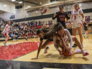 Camas sophomore Keirra Thompson, right, and Union sophomore Layla Senderson fight for a loose ball during Tuesday's 4A Greater St. Helens League game at Camas. The Papermakers went on to win 63-52.