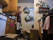 Steven Doble packs up items in his kitchen, preparing to move out of his Vancouver apartment where he's lived for eight years. Doble and his roommate are facing eviction, unable to pay their rent due in part to a long wait time for federal disability benefits.