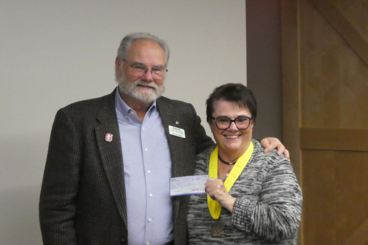 In a special celebration, Pam Moore presented a $9,000 check to John Brookens, past president of the Kiwanis Doernbecher Children's Cancer Program.