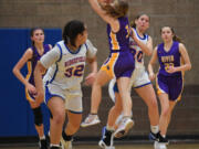 Columbia River sophomore Marley Myers,  shown here in January center, blocks a pass from Ridgefield sophomore Nora Martin.