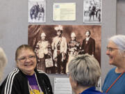 Mary Umtuch, left, descendent of Chief Umtuch, chats with visitors at Battle Ground Community Library including Bev Jones of Battle Ground, right, as they check out an exhibit featuring some of Battle Ground's Native American history Thursday.