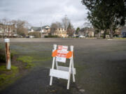 A no-parking sign blocks an entrance to the empty lot that is the proposed location of the third Safe Stay site in downtown Vancouver.