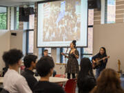 Portland-based Wren the Band performs for a crowd Tuesday at the Firstenburg Student Commons at Washington State University Vancouver. WSUV's Center for Intercultural Learning and Affirmation hosted the group, featuring percussionist Dominic Kukla, left, lead vocalist Chrissy Wood, center, and guitarist Andy Wilhelm, as part of a National Day of Racial Healing event.