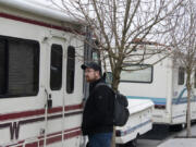 Cody Shaw of the Council for the Homeless knocks on the door of a recreational vehicle parked along Fort Vancouver Way while helping with the Point in Time Count on Thursday morning. Point in Time is an annual count of people experiencing homelessness, which feeds the yearly report.