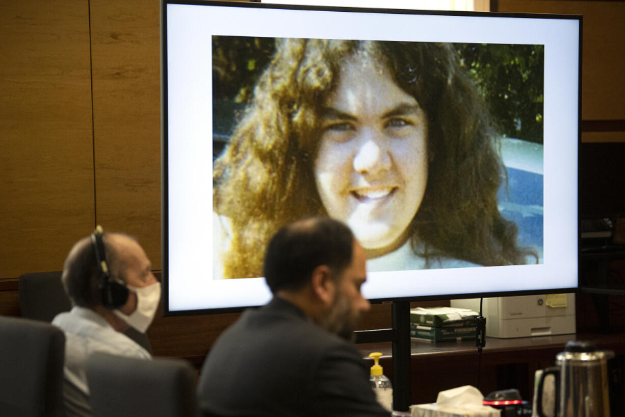 Suspected serial killer Warren Forrest, left, sits with his defense lawyer, Sean Downs, as the image of Martha Morrison is projected onto the screen during opening statements in his murder trial at the Clark County Courthouse on Tuesday morning.