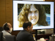 Suspected serial killer Warren Forrest, left, sits with his defense lawyer, Sean Downs, as the image of Martha Morrison is projected onto the screen during opening statements in his murder trial at the Clark County Courthouse on Tuesday morning.