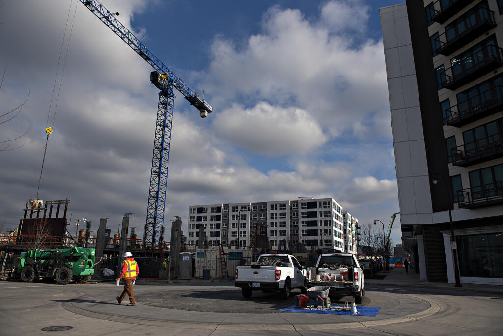 Construction is underway on Broadstone Apartments Block 19 near the Claro Building, background center, and The Columbia on the Waterfront Vancouver on Tuesday.