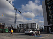 Construction is underway on Broadstone Apartments Block 19 near the Claro Building, background center, and The Columbia on the Waterfront Vancouver on Tuesday.