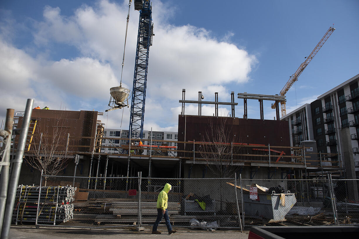 Construction is underway on Broadstone Apartments Block 19 near the Claro Building, background center, and The Columbia on the Waterfront Vancouver on Tuesday.