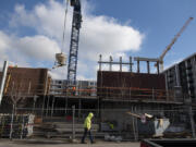 Construction is underway on Broadstone Apartments Block 19 near the Claro Building, background center, and The Columbia on the Waterfront Vancouver on Tuesday.