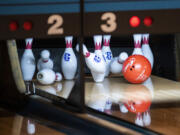 A ball crashes into pins Friday, Jan. 27, 2023, during the 4A/3A District Bowling Tournament at Husted’s Hazel Dell Lanes.