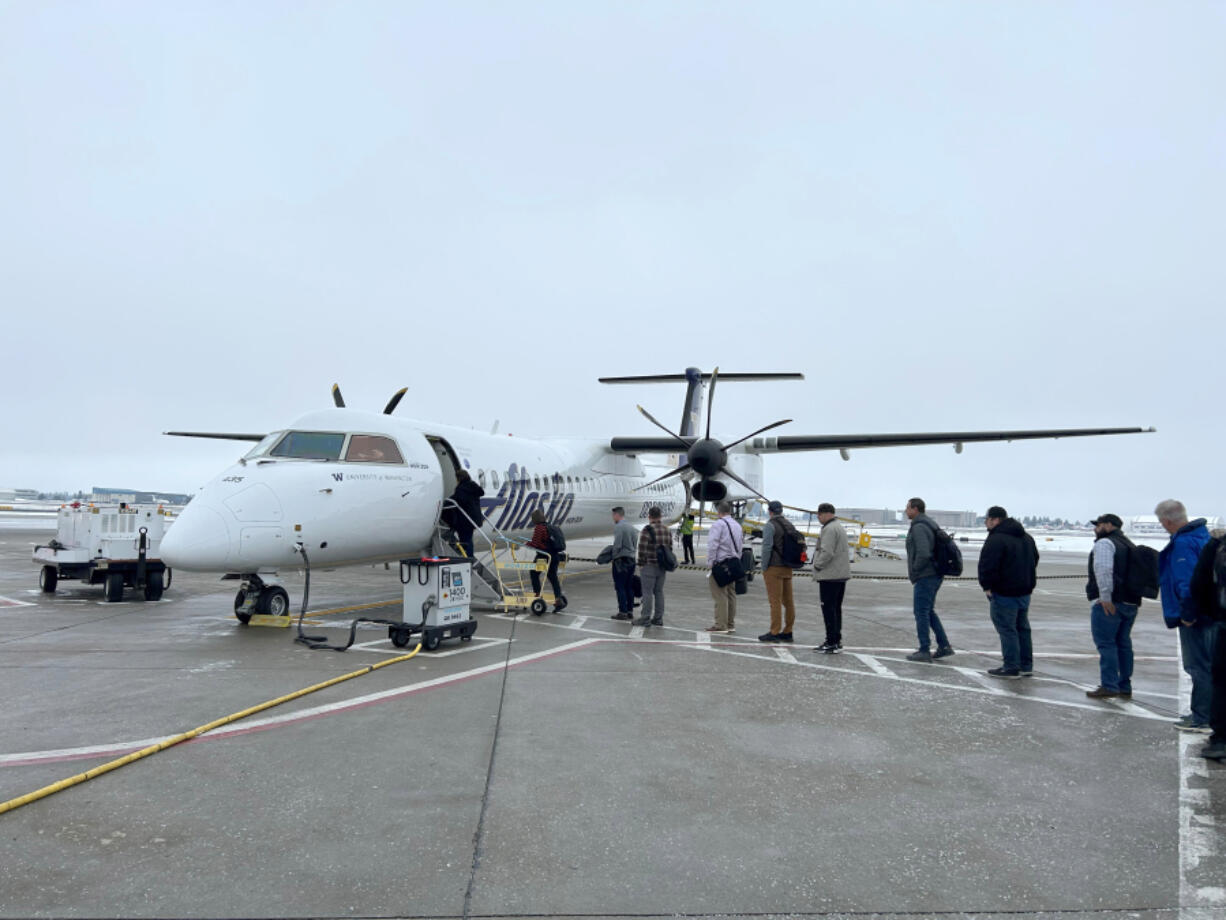 One of Horizon Air's last Bombardier Q400 planes loads Portland-bound passengers Monday at Spokane International Airport. The final flight for customers is Thursday as the airline completes its transition to an all-E175 jet fleet.