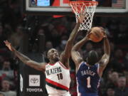 Portland Trail Blazers forward Nassir Little (10) tries to block a shot by Philadelphia 76ers guard James Harden (1) during the second half of an NBA basketball game in Portland, Ore., Thursday, Jan. 19, 2023.