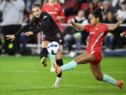 FILE - Portland Thorns FC forward Sophia Smith, left, kicks the ball against Kansas City Current defender Addisyn Merrick, right, during the first half of the NWSL championship soccer match, Saturday, Oct. 29, 2022, in Washington. Forward Sophia Smith was named the U.S. Soccer Female Player of the Year on Friday, Jan. 6, 2023, after leading the national team with 11 goals and starting in a team-high 17 matches.
