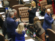 House Republican leader J.T. Wilcox shakes hands with Rep Tana Senn after addressing legislators on the first day of the legislative session at the Washington state Capitol in Olympia, Wash., on Monday, Jan. 9, 2023.