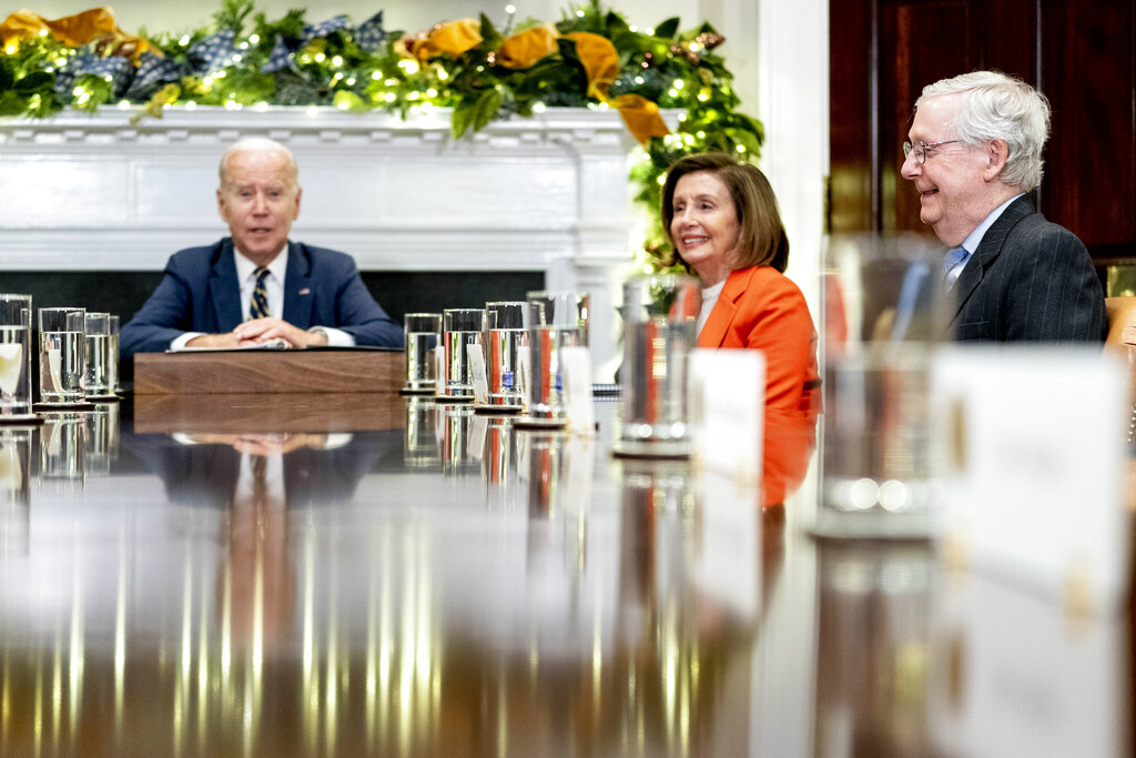 FILE - President Joe Biden, left, accompanied by House Speaker Nancy Pelosi of Calif., second from right, and Senate Minority Leader Mitch McConnell of Ky., right, speaks at the top of a meeting with congressional leaders to discuss legislative priorities for the rest of the year, Nov. 29, 2022, in the Roosevelt Room of the White House in Washington.  By temperament and manner, Joe Biden and Mitch McConnell are decidedly mismatched. But as the days of divided government under Biden begin, their long relationship will become even more vital.