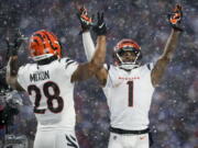 Cincinnati Bengals wide receiver Ja'Marr Chase (1) and running back Joe Mixon celebrate touchdown against the Buffalo Bills on Sunday in Orchard Park, N.Y.