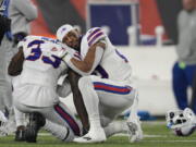 Buffalo Bills' Siran Neal (33) and Nyheim Hines react after teammate Damar Hamlin was injured during the first half of an NFL football game against the Cincinnati Bengals, Monday, Jan. 2, 2023, in Cincinnati.