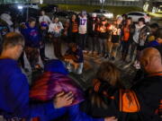 Fans gather outside of University of Cincinnati Medical Center, late Monday, Jan. 2, 2023, in Cincinnati, where Buffalo Bills' Damar Hamlin was taken after collapsing on the field during an NFL football game against the Cincinnati Bengals.