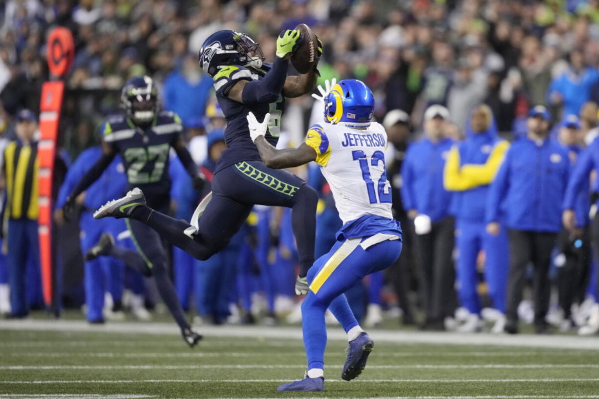 Seattle Seahawks safety Quandre Diggs (6) intercepts a pass intended for Los Angeles Rams wide receiver Van Jefferson (12) during the overtime of an NFL football game Sunday, Jan. 8, 2023, in Seattle.