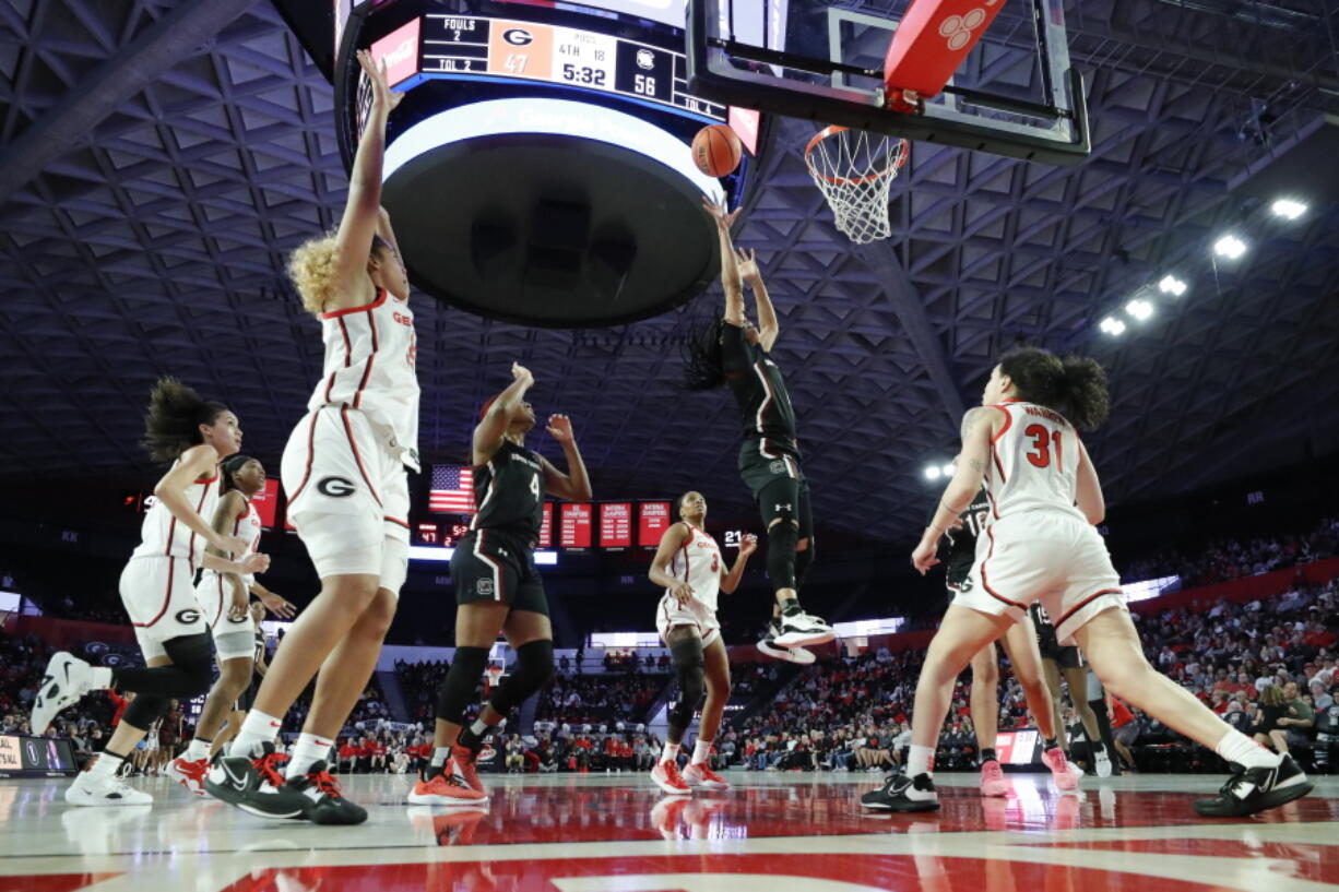 South Carolina guard Zia Cooke, second from right, shoots over Georgia guard Audrey Warren, right, during the second half of an NCAA college basketball game in Athens, Ga., Monday, Jan. 2, 2023.