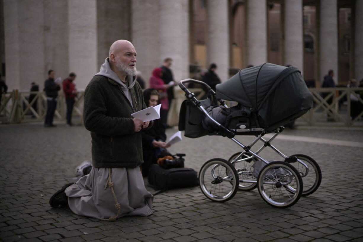 Faithful attend the funeral mass for late Pope Emeritus Benedict XVI in St. Peter's Square at the Vatican, Thursday, Jan. 5, 2023. Benedict died at 95 on Dec. 31 in the monastery on the Vatican grounds where he had spent nearly all of his decade in retirement.