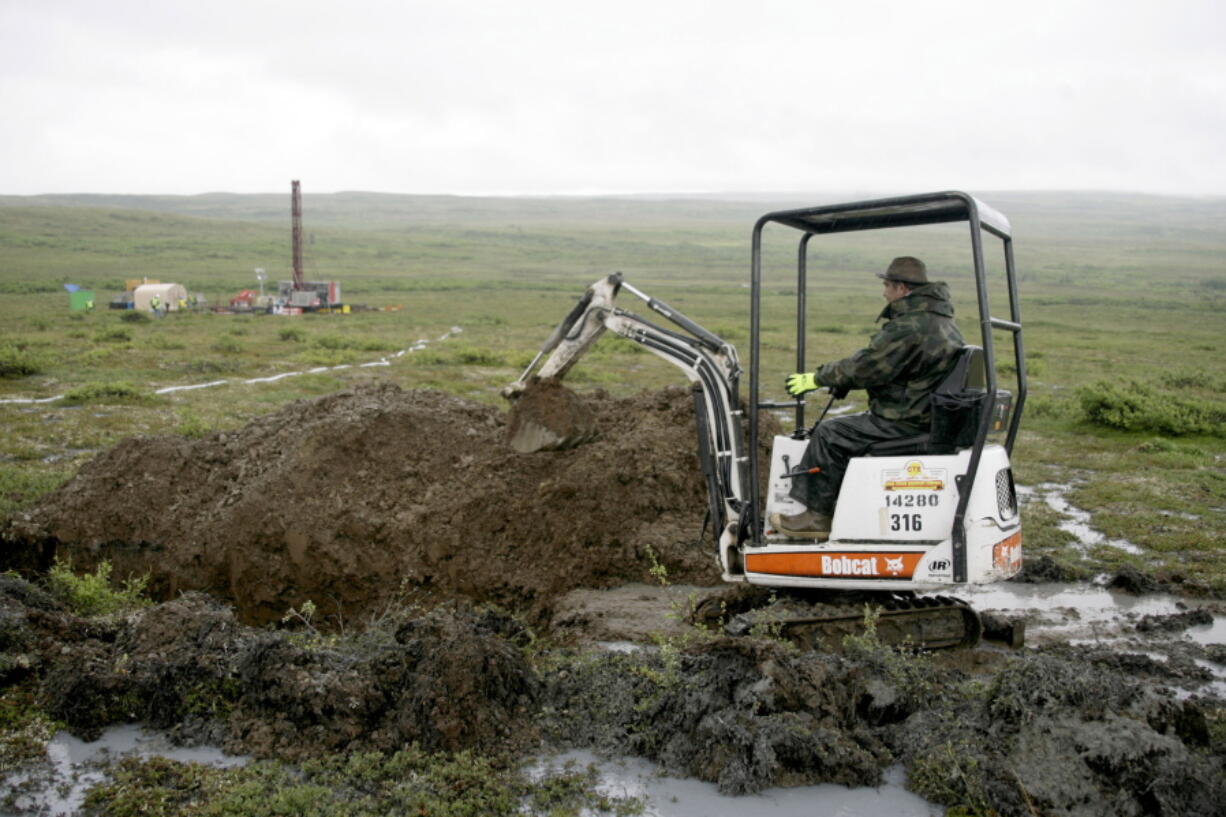 FILE - A worker with the Pebble Mine project digs in the Bristol Bay region of Alaska near the village of Iliamma, Alaska, July 13, 2007. The U.S. Environmental Protection Agency announced a decision Tuesday, Jan. 31, 2023, that would block plans for the proposed Pebble Mine, a copper and gold project in southwest Alaska.